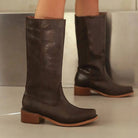 Elegant black knee-high boots by Lumina Wear featuring a stacked heel and sleek design, ideal for stylish women's footwear.