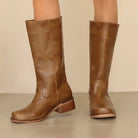 Black knee-high boots for women with stacked heels, stylish and elegant, by Lumina Wear, shown on a neutral background.