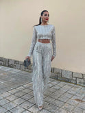 Elegant Lumina Wear Seraphina cropped sequin two-piece evening dress with long sleeves, featuring a fitted top and matching skirt.