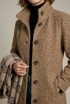Elegant women's mid-length wool coat with notch collar and button front by Lumina Wear, shown in a classic style.