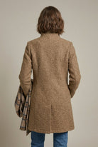 Elegant women's wool coat with notch collar and button front by Lumina Wear, mid-length style perfect for sophisticated winter looks.