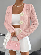 Elegant white crochet women's cardigan with floral buttons from Lumina Wear, featuring intricate knit pattern and charming button details.