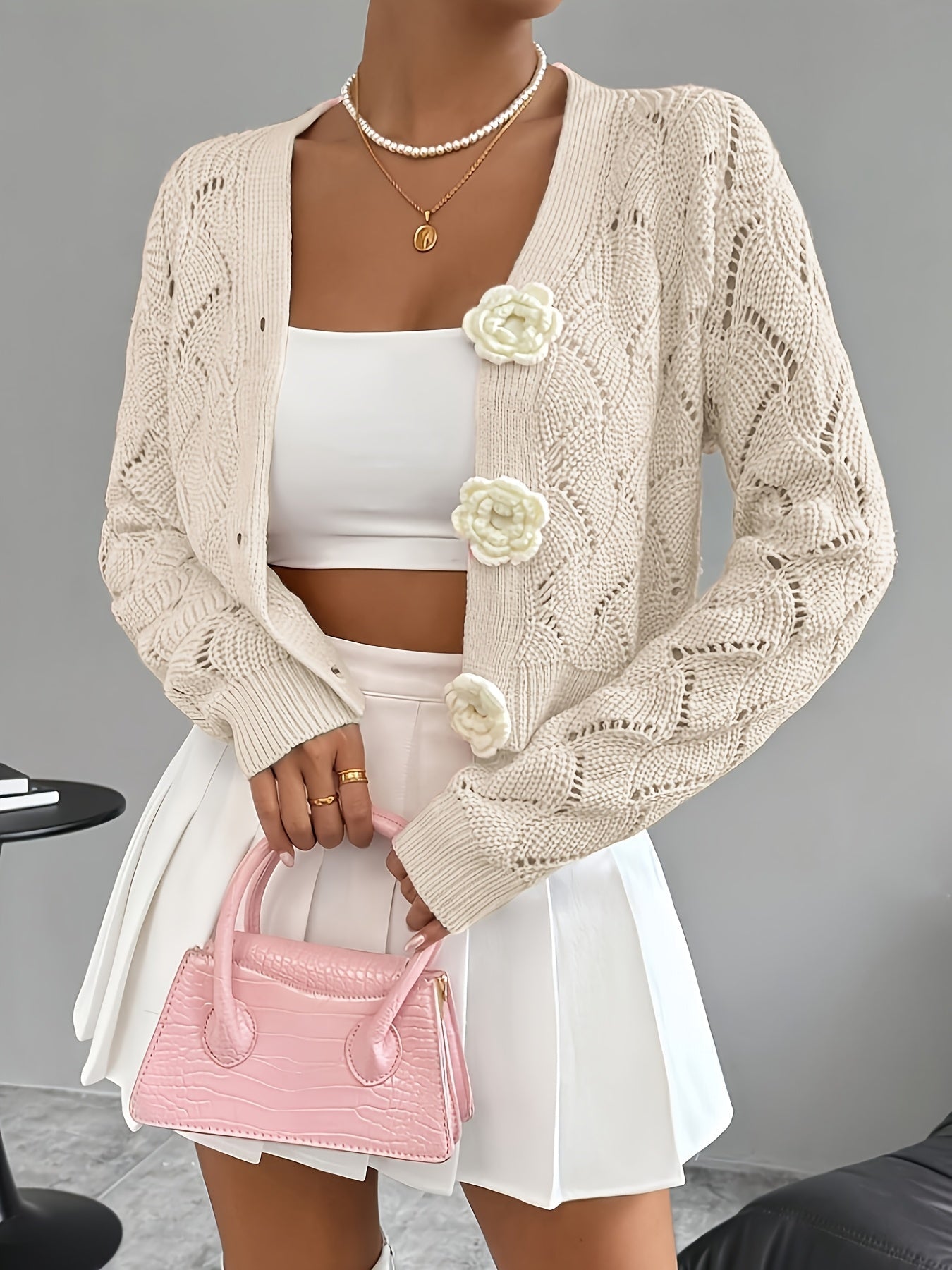 Elegant white crochet women's cardigan by Lumina Wear featuring floral buttons and delicate knit details.