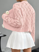 White crochet women's cardigan with floral buttons from Lumina Wear, featuring elegant design and delicate knit pattern.