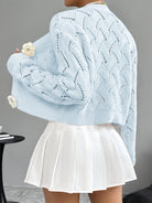Elegant white crochet cardigan for women by Lumina Wear featuring floral button details and a stylish, delicate design.