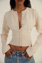 Women’s fitted ribbed cropped cardigan with button closure by Lumina Wear, featuring a stylish, snug fit and textured knit design.
