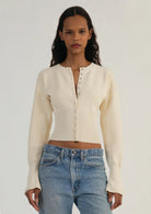 Fitted ribbed cropped women's cardigan with button closure from Lumina Wear, featuring a stylish and snug design.