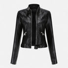 Isabella vegan leather fitted jacket with waist belt, structured design, in black, worn by a woman with stylish accessories.
