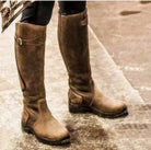 Women's knee-high buckle strap boots with ridged sole from Lumina Wear, featuring stylish buckles and sturdy traction.