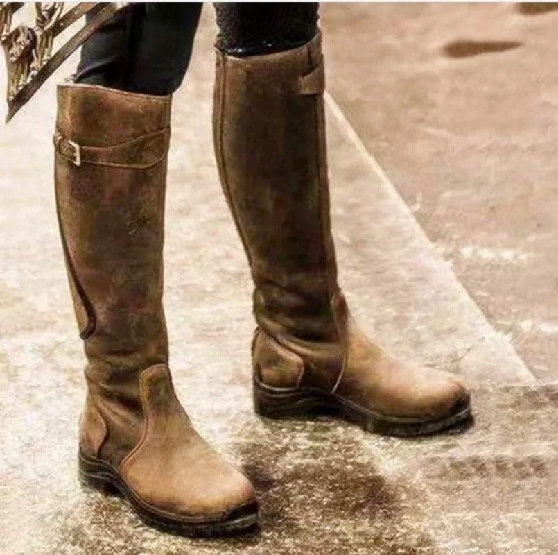 Women's knee-high buckle strap boots with ridged sole from Lumina Wear, featuring stylish buckles and sturdy traction.