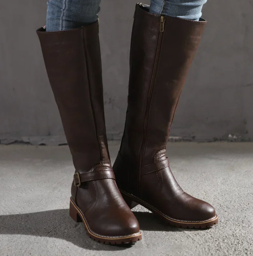 Women's knee-high buckle strap boots with side zipper from Lumina Wear, featuring stylish straps and sleek design.