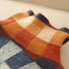 Multi-color checked relaxed fit women's sweater with mock neck by Lumina Wear, featuring bold pattern and cozy fabric.