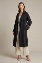 Isabella oversized black trench coat with structured lapels from Lumina Wear, shown on a model with a stylish, modern silhouette.