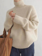 Isabella Lumina black oversized turtleneck sweater with relaxed fit, featuring soft knit fabric and cozy design.