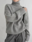 Black oversized turtleneck sweater by Lumina Wear featuring a relaxed fit and cozy knit texture.