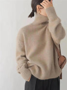Black oversized turtleneck sweater by Lumina Wear featuring a relaxed fit and cozy style, displayed on a model.