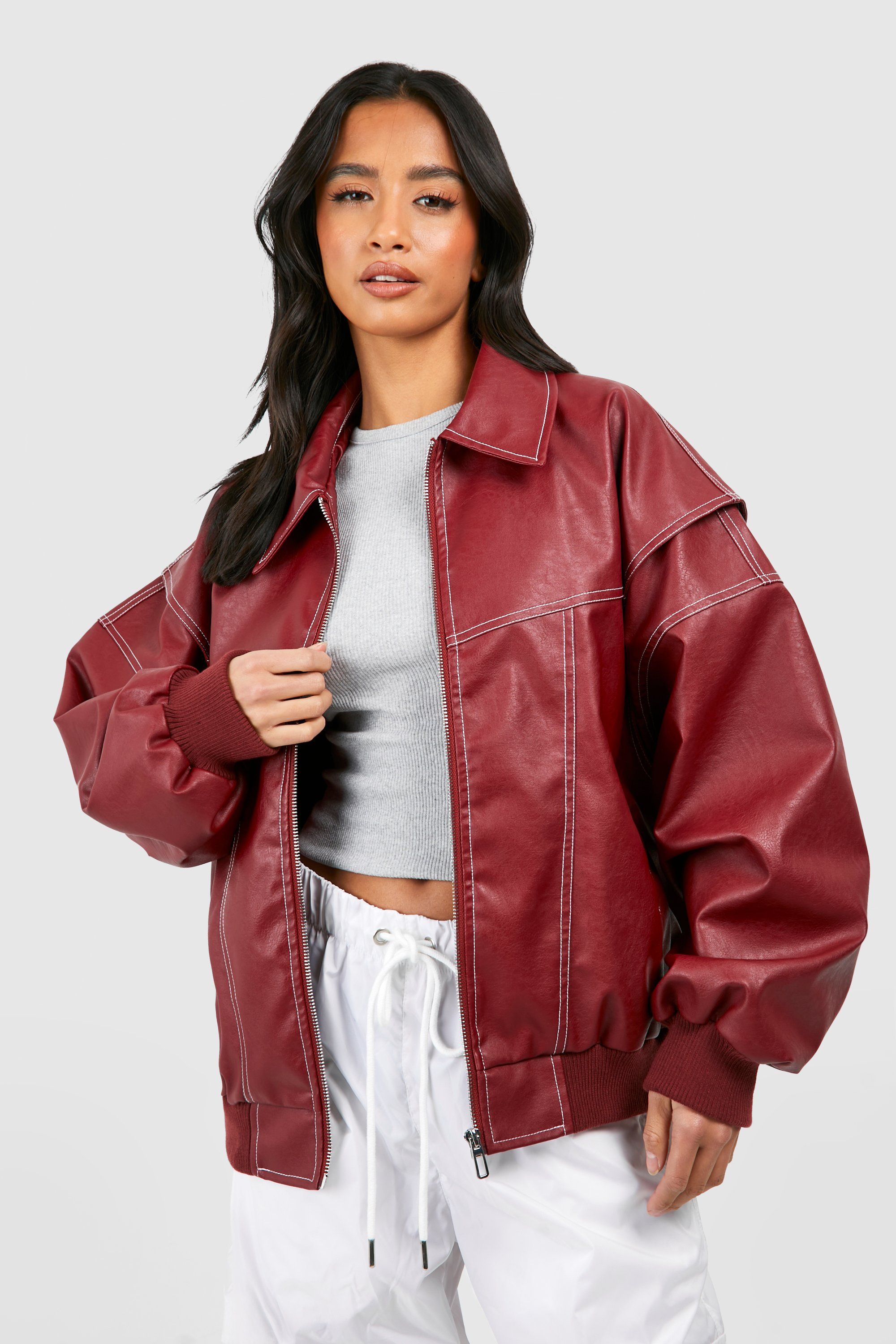 Isabella oversized black vegan leather bomber jacket with ribbed cuffs by Lumina Wear, styled for a trendy casual look.