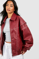 Black vegan leather oversized bomber jacket with ribbed cuffs from Lumina Wear, featuring a stylish and modern design.