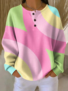 Lumina Wear Isabella oversized color-block waffle-knit women's sweater with henley placket, featuring bold patterns and cozy knit fabric.