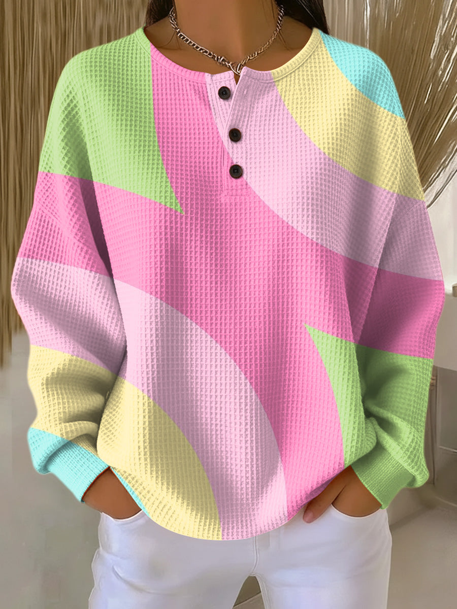 Lumina Wear Isabella oversized color-block waffle-knit women's sweater with henley placket, featuring bold patterns and cozy knit fabric.