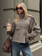 Oversized houndstooth blazer with funnel neck and double-breasted front by Lumina Wear, styled on a woman.