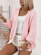 Light beige oversized rib-knit long cardigan with batwing sleeves from Lumina Wear's Isabella collection, styled open on a woman.