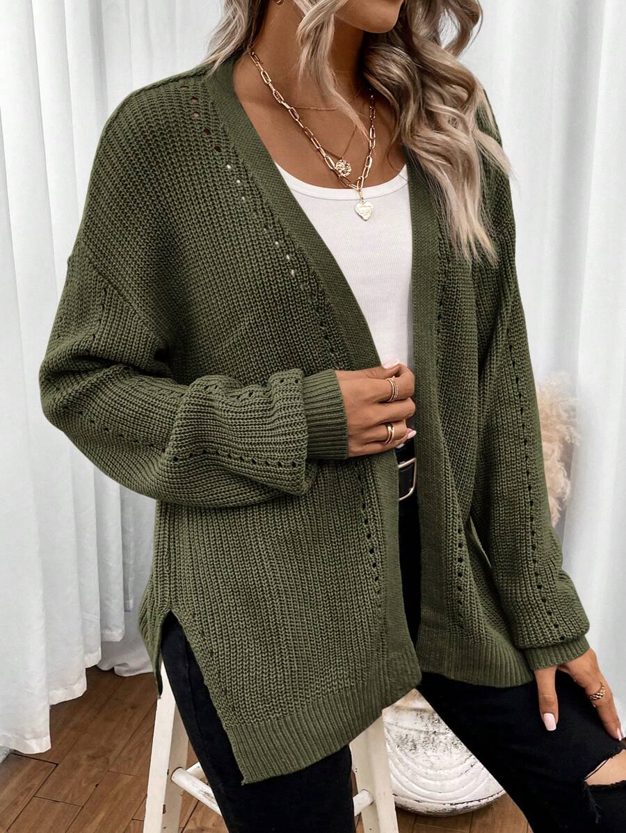Black pointelle knit cardigan sweater with side split hem from Lumina Wear, styled on a model with long sleeves and a relaxed fit.