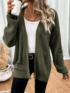 Black pointelle knit women's cardigan sweater with side split hem from Lumina Wear, featuring a cozy and stylish design.