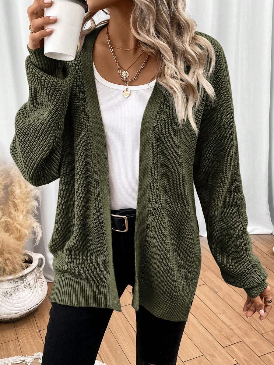 Black pointelle knit women's cardigan sweater with side split hem from Lumina Wear, featuring a cozy and stylish design.