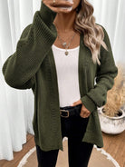 Black pointelle knit women's cardigan sweater with side split hem by Lumina Wear, styled with long sleeves and open front.