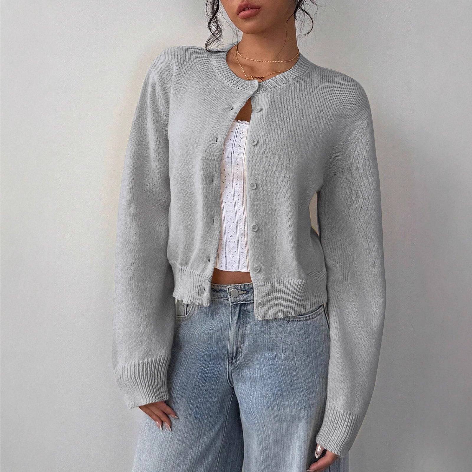 White cropped cardigan sweater with ribbed trim from Lumina Wear, featuring a relaxed fit and soft knit texture.