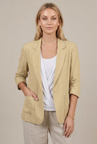 Light beige linen blazer for women with relaxed fit and ruched sleeves by Lumina Wear, shown on a model.