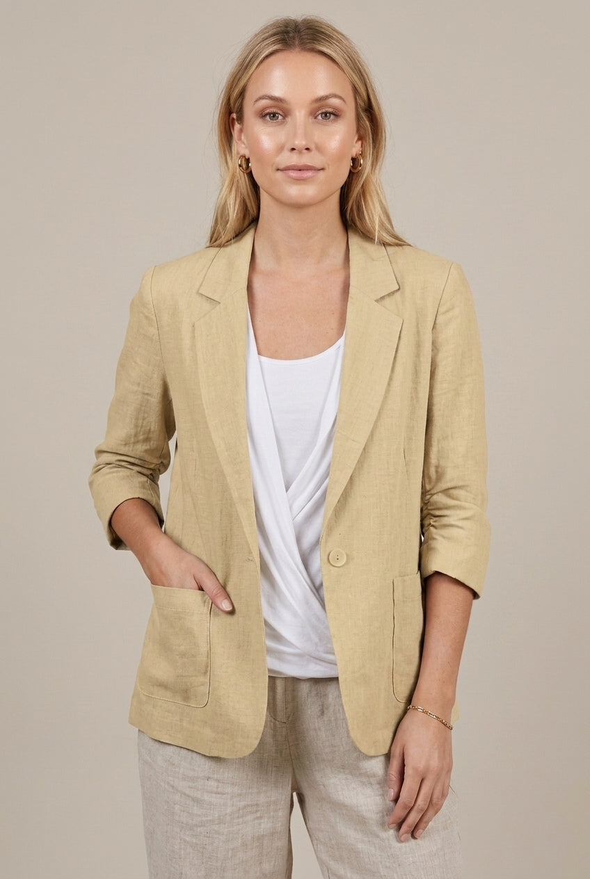 Light beige linen blazer for women with relaxed fit and ruched sleeves by Lumina Wear, shown on a model.