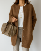 Light gray women's long cardigan by Lumina Wear featuring a relaxed fit and patch pockets, styled for casual comfort.