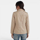 Lumina Wear Isabella relaxed fit utility jacket with adjustable collar, shown in a casual outdoor setting.