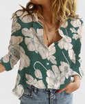 Light beige Isabella Lumina Wear relaxed V-neck blouse with button front, displayed on a hanger.