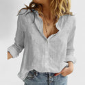 Light blue Isabella Lumina Wear relaxed V-neck blouse with button front, casual style, displayed on a hanger.
