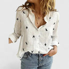 Light beige Isabella Lumina Wear relaxed V-neck blouse with button front, casual style, and long sleeves.