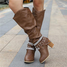 Lumina Wear women's knee-high boots with studded straps, slouch design, and block heel, showcasing stylish footwear.