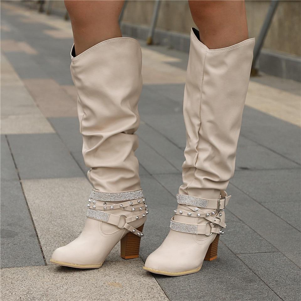 Lumina Wear women's knee-high boots with studded straps, slouch design, and block heel for stylish comfort.