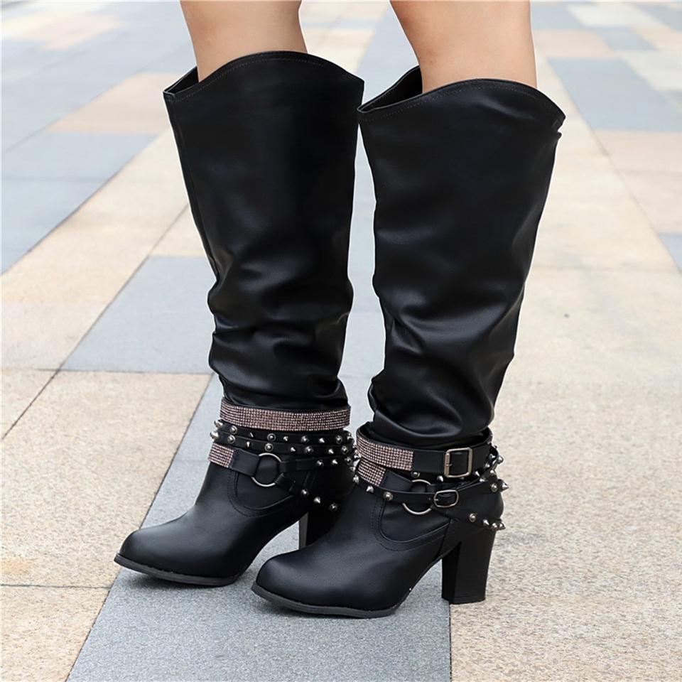Women’s knee-high boots with studded straps and block heels from Lumina Wear, featuring a slouch design and stylish black finish.