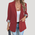 Lumina Wear Isabella tailored blazer with roll-up sleeves and flap pockets, shown on a model in a professional setting.