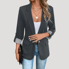 Lumina Wear Isabella women's tailored blazer featuring roll-up sleeves and flap pockets, shown on a model.