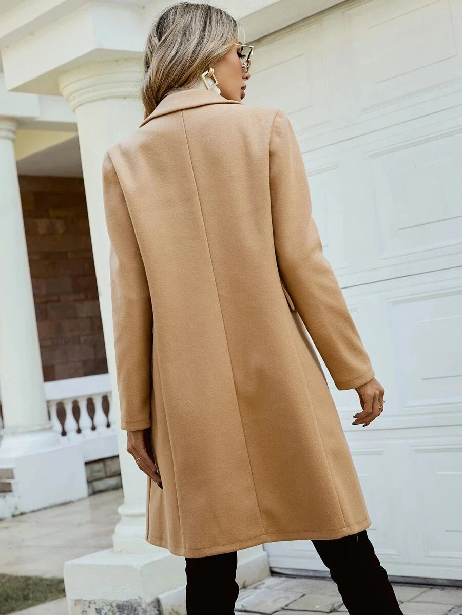 Elegant Isabella Lumina Wear tailored double-breasted knee-length overcoat displayed on a hanger with a classic design and neutral color.