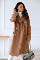 Woman wearing Lumina Wear Isabella tailored longline winter trench coat with structured shoulders, stylish and elegant winter outerwear.