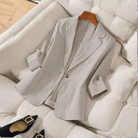 Women's striped blazer with notch lapel from Lumina Wear, tailored fit, featuring classic vertical stripes and a sophisticated style.