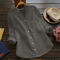 Light blue Jessica Lumina Wear relaxed fit button blouse with timeless design, displayed on a hanger.