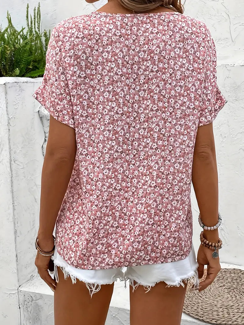 Light-colored floral blouse with button front from Lumina Wear's Joanna relaxed blouse collection, displayed on a hanger.