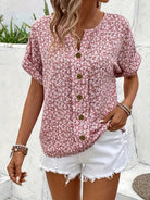 Relaxed floral blouse by Lumina Wear featuring a button front and lightweight fabric, styled with long sleeves and a casual fit.