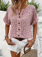 Light floral blouse from Lumina Wear featuring a relaxed fit and button front, styled with soft fabric and vibrant floral pattern.